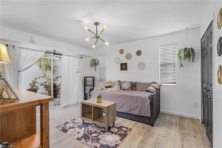 Back Bedroom with a closet, a chandelier, and light wood-type flooring. Perfect for a sitting room or TV Room.