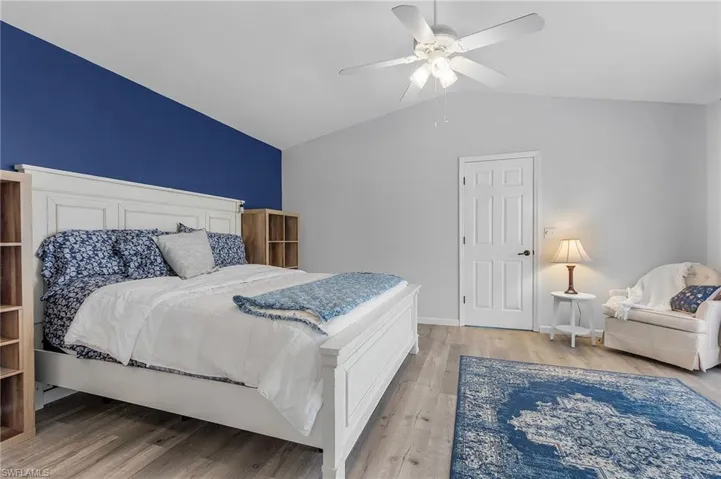 Bedroom featuring lofted ceiling, hardwood / wood-style flooring, and ceiling fan