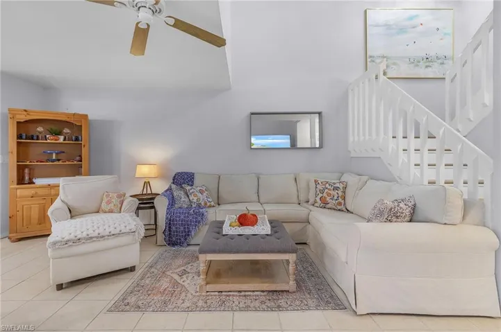 Tiled living room featuring ceiling fan