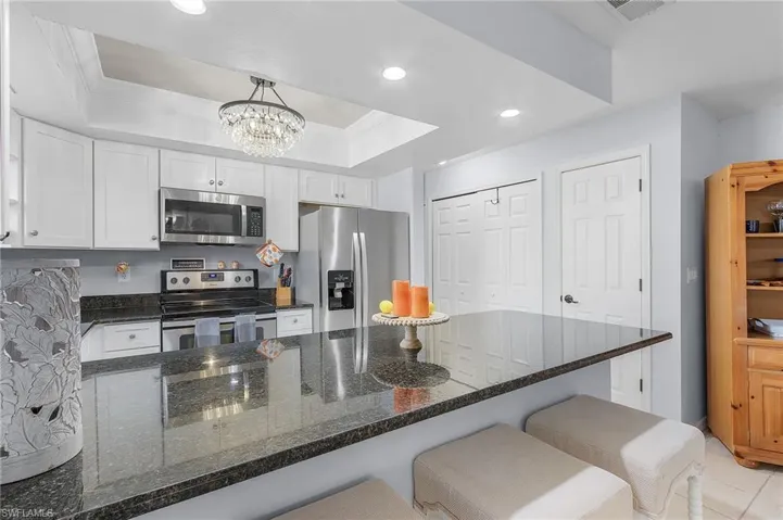Kitchen counter overlaps for a quad-setting of bar stools.