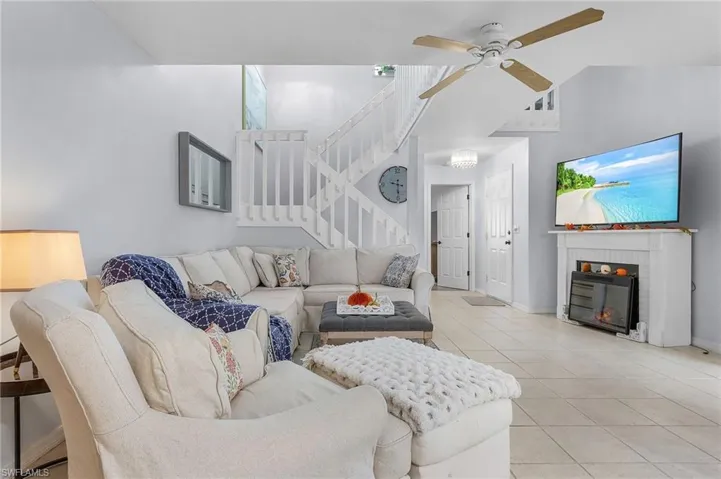 Living room featuring ceiling fan and tile patterned floors