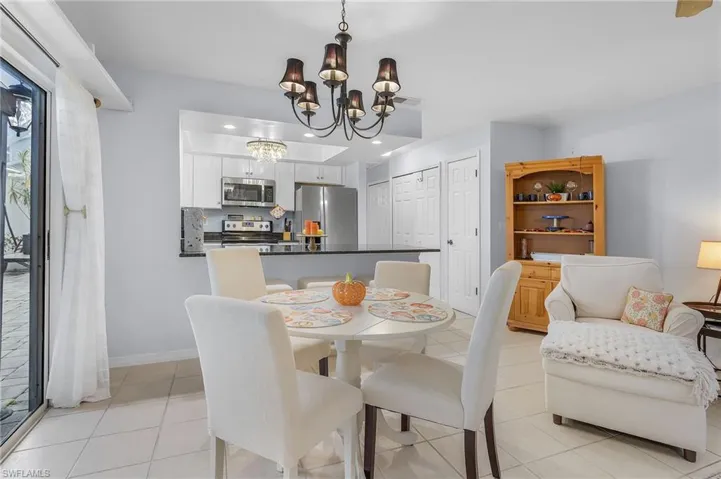Dining room featuring light tile patterned floors and a chandelier
