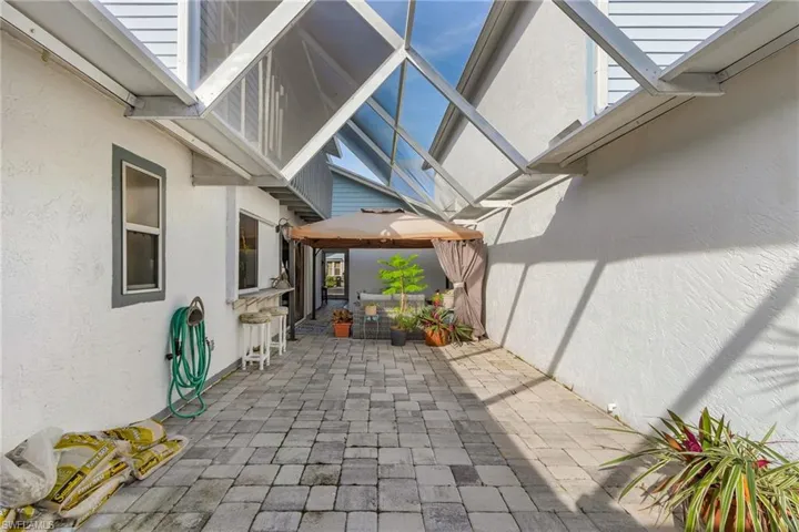 View of patio with a gazebo and a lanai