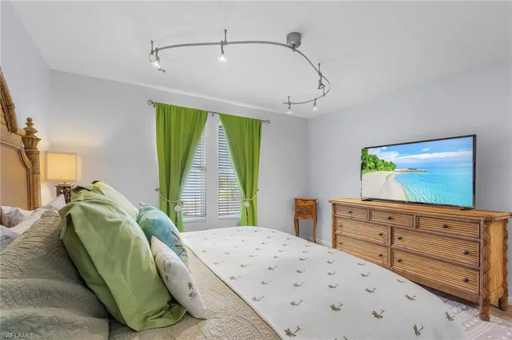 Bedroom featuring rail lighting