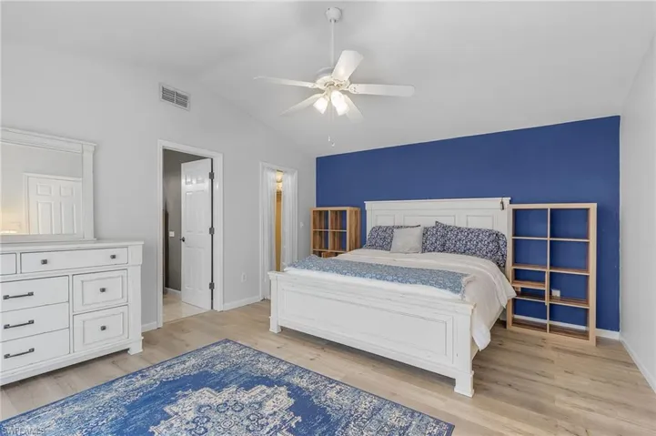 Very spacious, Master Retreat with light hardwood / wood-style flooring, vaulted ceiling, and ceiling fan