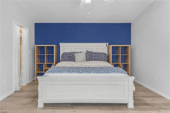 Bedroom featuring ceiling fan and light hardwood / wood-style flooring