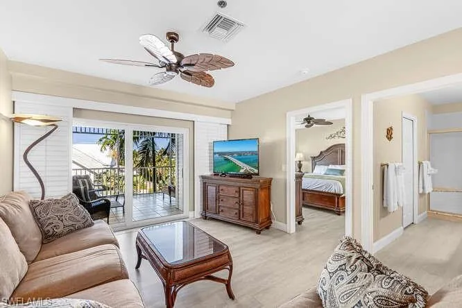 Living room with a ceiling fan and light wood finished floors