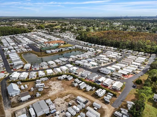 Aerial overview of property's location featuring a large body of water and nearby suburban area
