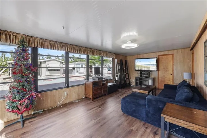 Living room with wooden walls and wood finished floors