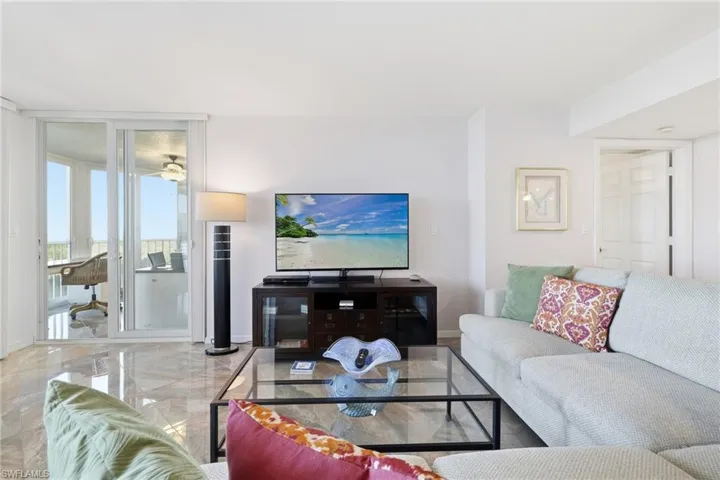 Living area with marble tiled floors and expansive windows