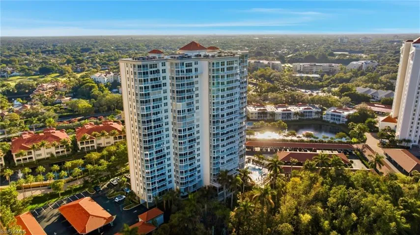 View of apartment building / complex with view of wooded area