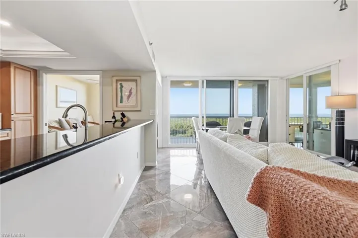 Living room with expansive windows and light marble finish flooring