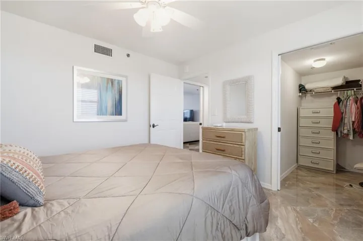 Bedroom featuring a spacious closet and a ceiling fan