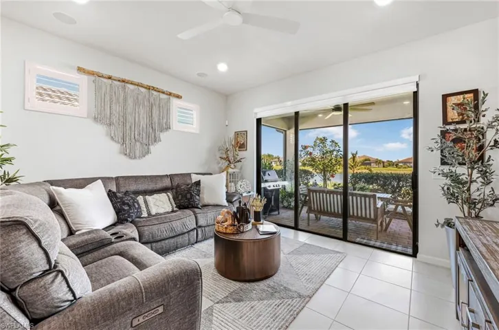 Living area featuring large format white tile flooring and direct patio access