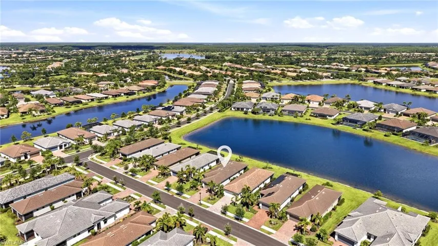 Expansive residential community featuring numerous homesites, a network of interconnected waterways, mature landscaping, and paved streets with brick paver driveways