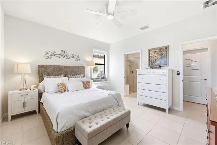 Spacious room with light tile flooring, neutral wall tones, and a ceiling fan