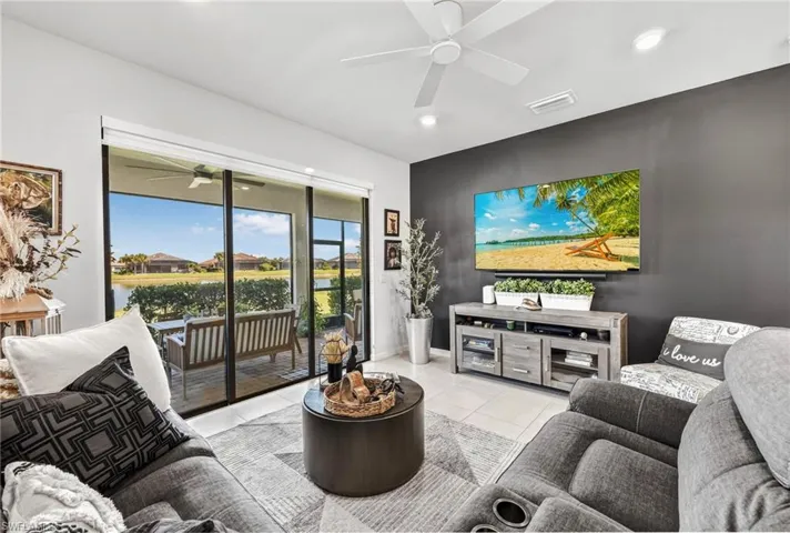 Sliding glass doors opening on either side to a screened lanai with water and community views