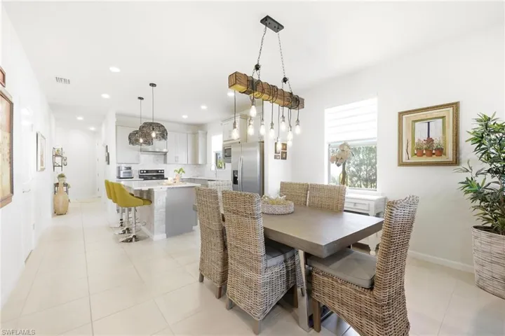Dining area featuring a wood-finish dining table and a unique beam-style chandelier