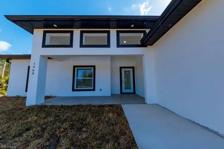 View of exterior entry with stucco siding
