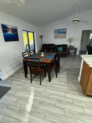 Dining room featuring ceiling fan and lofted ceiling