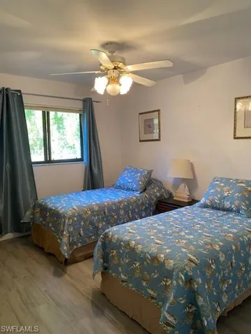 Bedroom with hardwood / wood-style flooring and ceiling fan