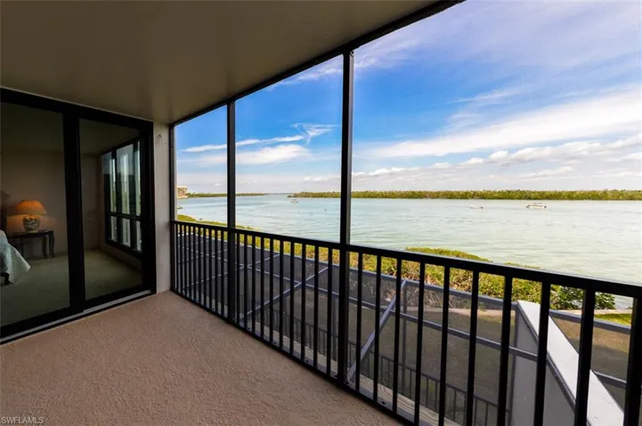 DRAMATIC ESTERO BAY VIEWS FROM NEWLY REFURBISHED LANAI.  ENTRANCE TO OWNER'S SUITE SHOWN AT LEFT.