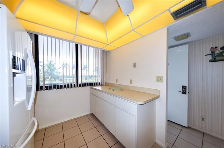 KITCHEN.  UNIT ENTRANCE SHOWN AT RIGHT.