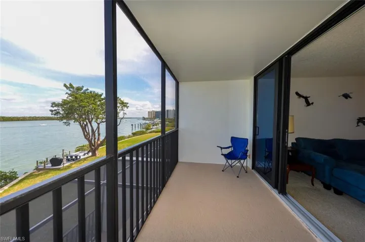 FULL ESTERO BAY VIEWS FROM NEWLY REFURBISHED LANAI.  IMPACT RESISTANT SLIDING DOORS LEAD TO LIVING AREA.