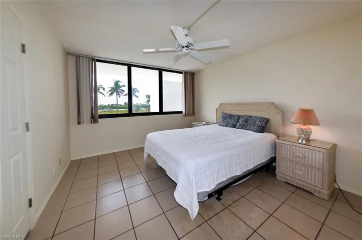SPACIOUS GUEST BEDROOM WITH SOUTHERN EXPOSURE, IMPACT-RESISTANT WINDOWS.