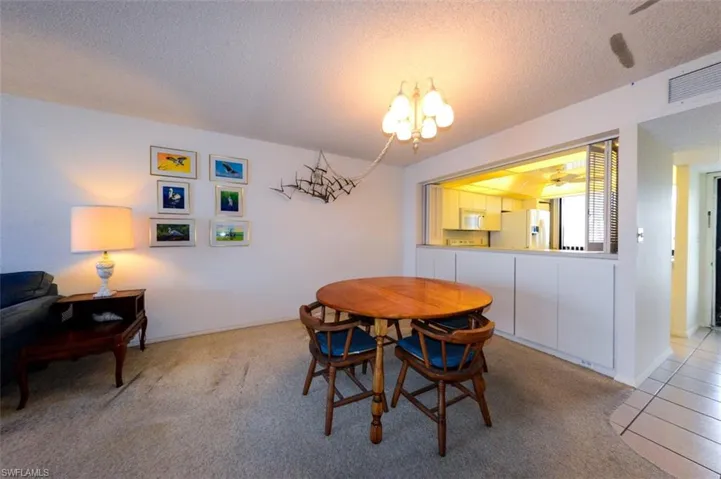 DINING AREA.  PASS-THROUGH TO KITCHEN WITH LOUVERED SHUTTERS.  EXTRA STORAGE.