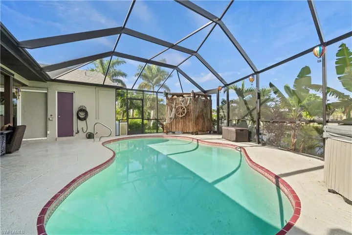 View of pool with a patio and glass enclosure