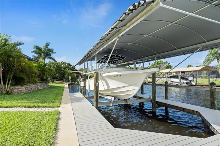 Dock area featuring a lawn and a water view