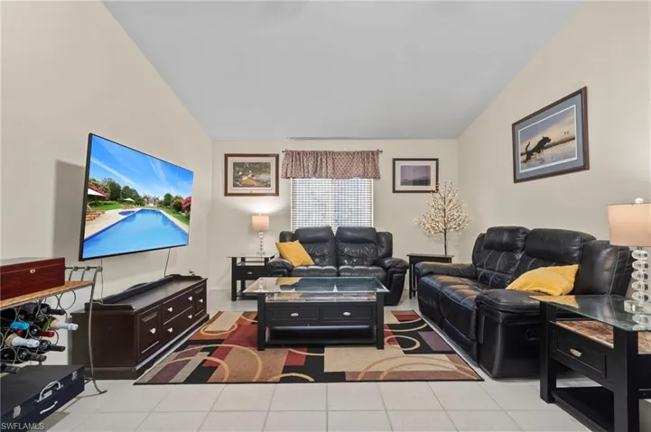 Tiled living room with lofted ceiling