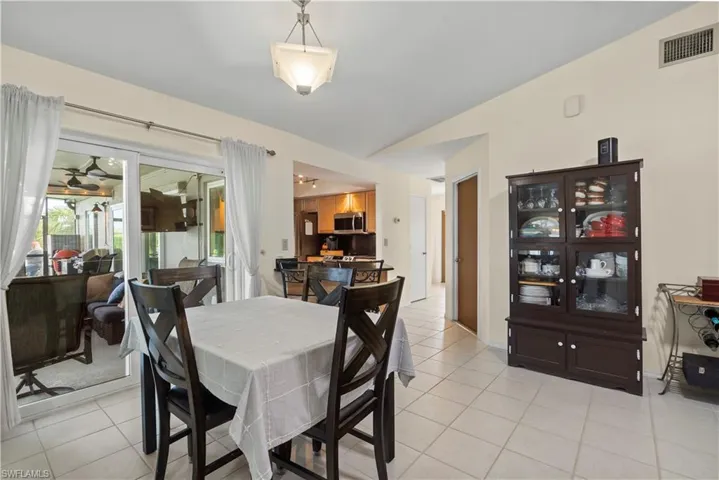 Tiled dining space with lofted ceiling