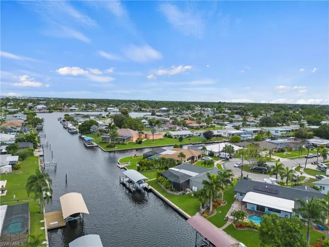 Birds eye view of property with a water view