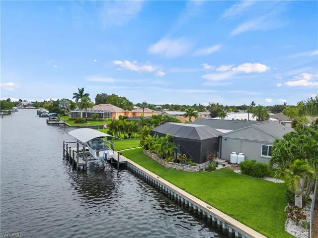 View of dock with a yard and a water view