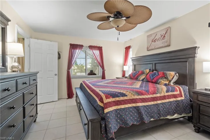 Bedroom featuring ceiling fan and light tile floors