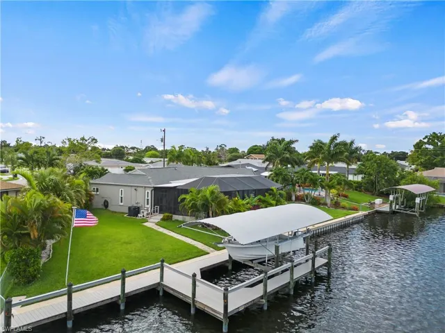 Dock area with a yard and a water view