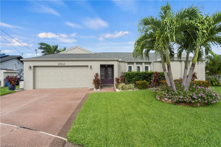 Ranch-style home with a garage and a front yard