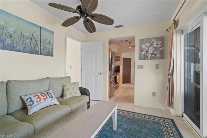 Living room featuring tile flooring and ceiling fan