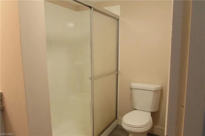 Bathroom with a shower with door and toilet
