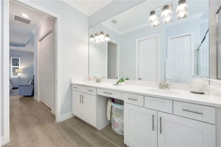Bright and well-appointed primary bathroom with a spacious dual-sink vanity.