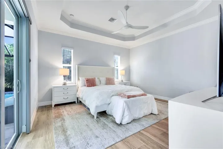 Primary suite featuring tray ceilings and plenty of natural light.