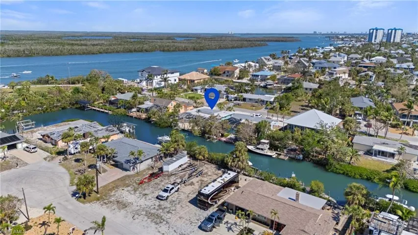 Aerial perspective of suburban area with a nearby body of water - Virtually Edited Image