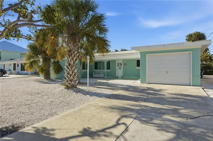 Ranch-style house featuring driveway and a garage - Virtually Edited Image