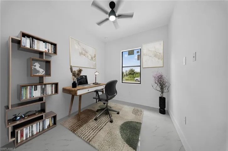 Home office featuring light marble finish floors and ceiling fan