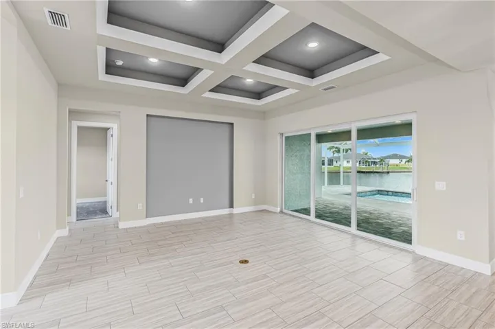 Unfurnished room with coffered ceiling, beam ceiling, wood tiled floors, and recessed lighting