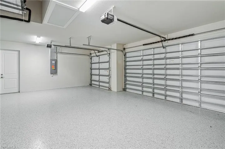 Garage with a garage door opener and electric panel