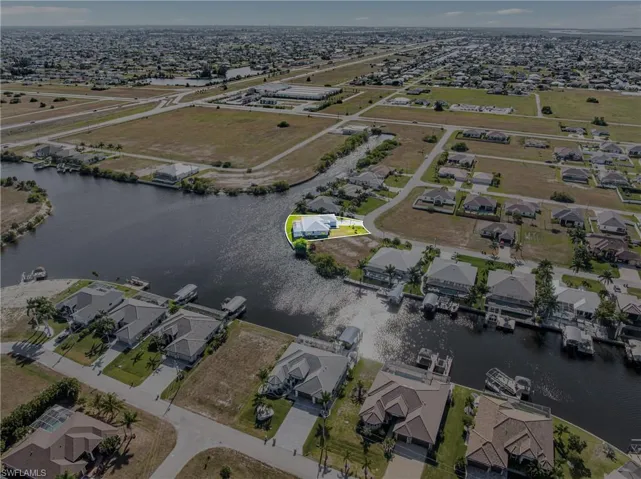 Aerial overview of property's location with nearby suburban area and a nearby body of water