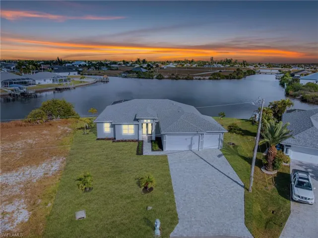 Aerial view at dusk of a water view and a residential view